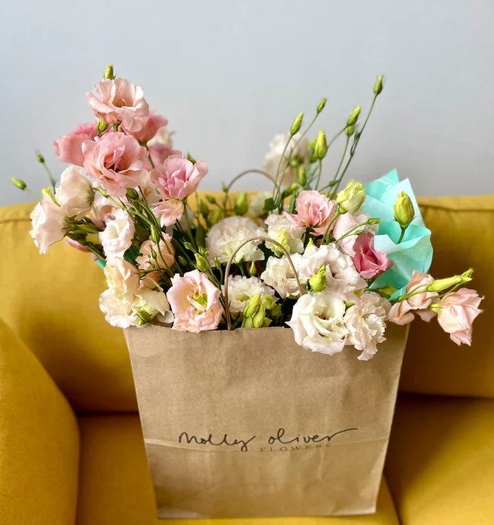 modern deluxe seasonal flower arrangement in ceramic vase compostable recyclable low waste packaging summer peach and pink lisianthus flower delivery nyc brooklyn