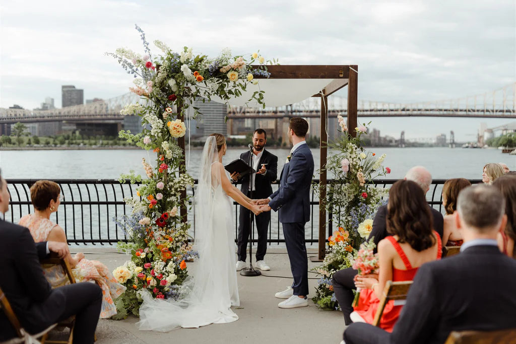 NYC Jewish wedding chuppah seasonal flowers peonies delphinium sunset colors sound river studios lic long island city queens