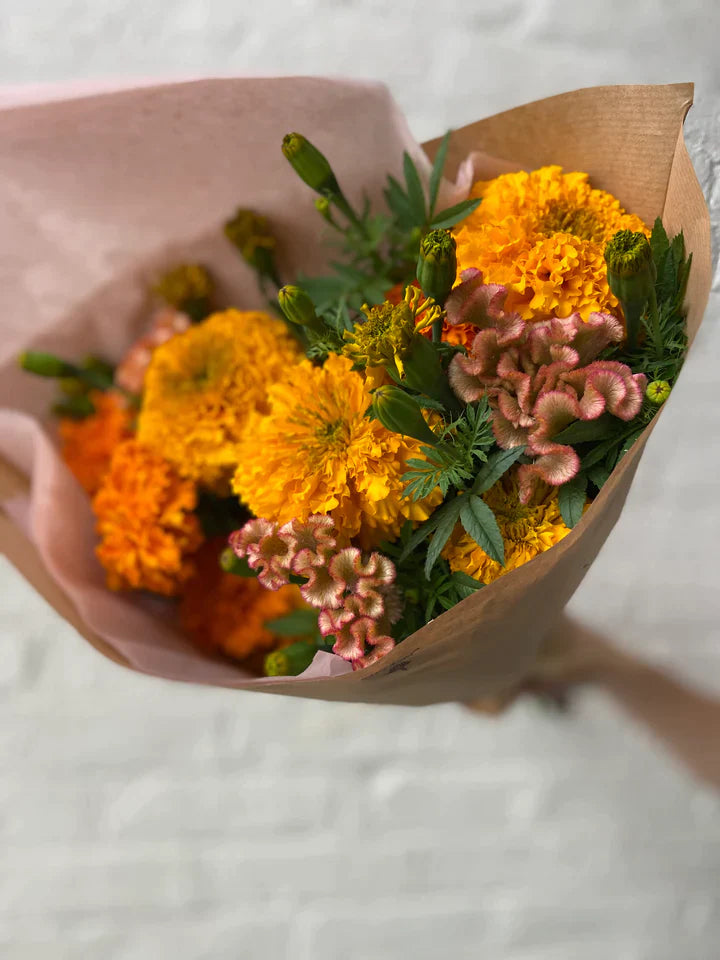 Handtied bouquet gift compostable paper seasonal bouquet local flowers brooklyn marigolds and crest celosia