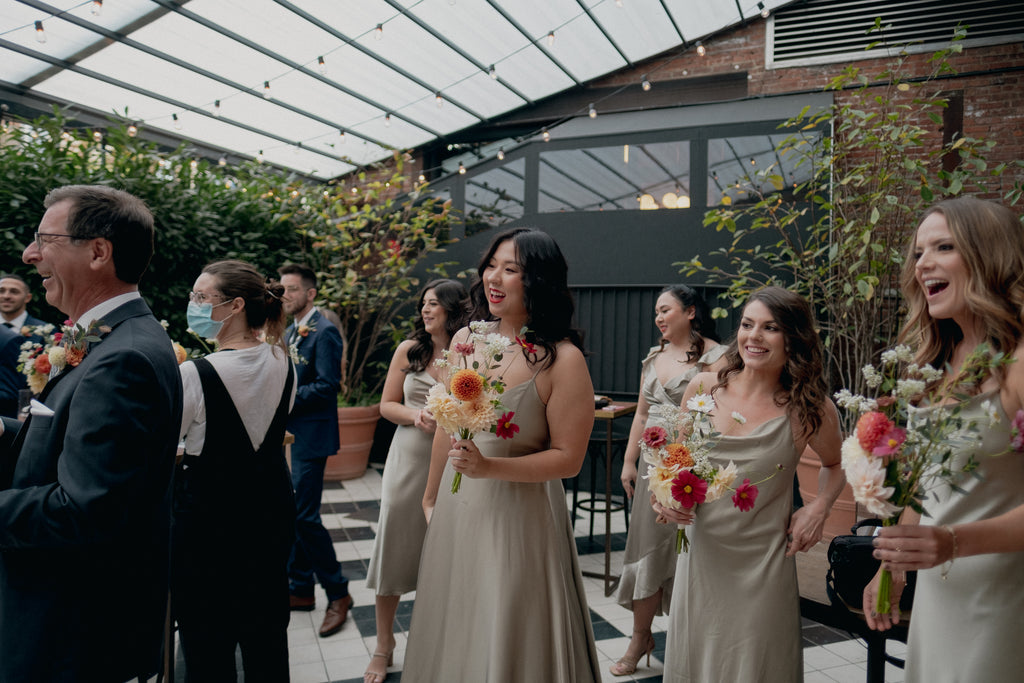 Williamsburg Brooklyn Wythe Hotel Sustainable Fall October Wedding Molly Oliver Flowers Apricot Sage Cranberry Burgundy Bridesmaid bouquets Candid photo Chelisse Michael Photography Rubenza Cosmos Queen Red Lime Zinnia Sage dresses